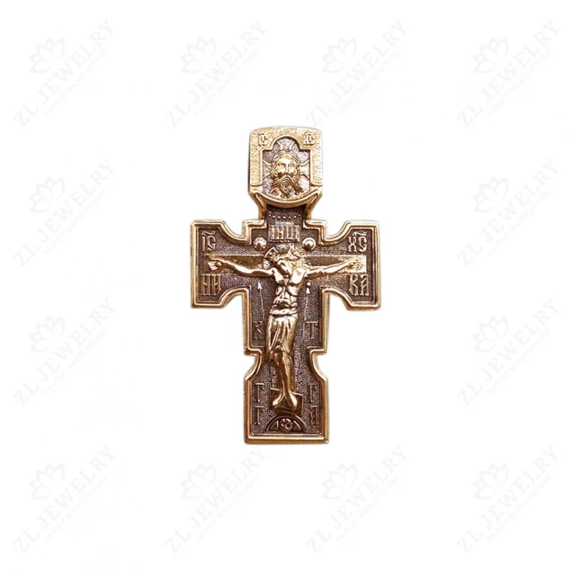 Cross with the faces of the saints from red gold